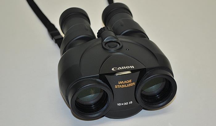 Product photo: Canon 10x30 IS binoculars on gray background