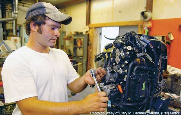 Mechanic Working on Boat Engine