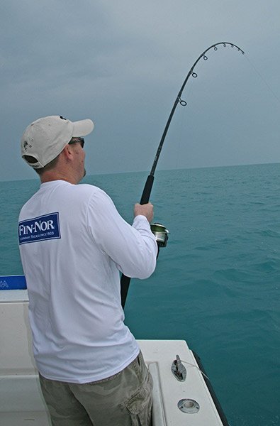 Man Reeling in King Mackerel