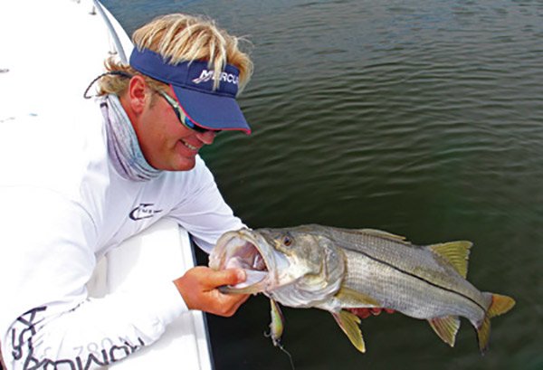 Angler Hauling in a Snook