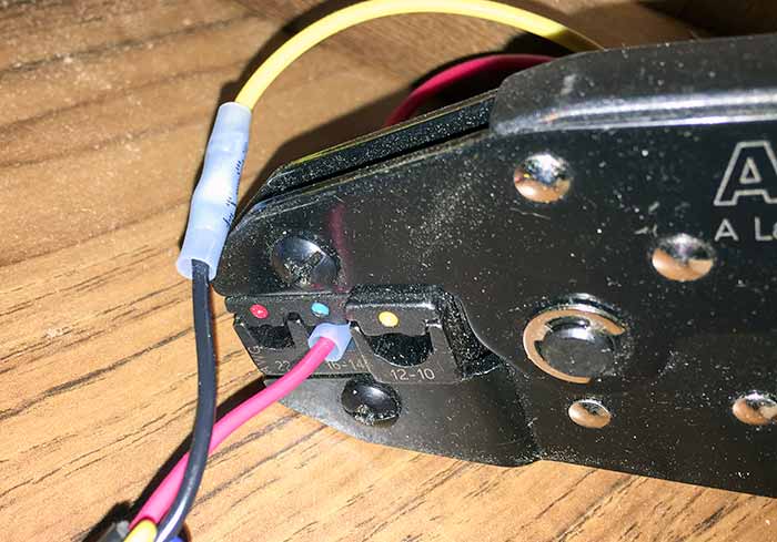 A black tool crimping connectors