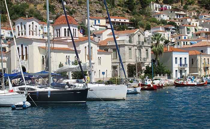 Several boats tied up against intricate white buildings