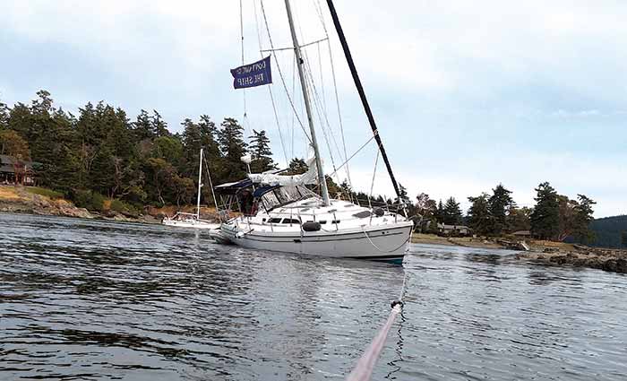 Sailboat being towed after running aground