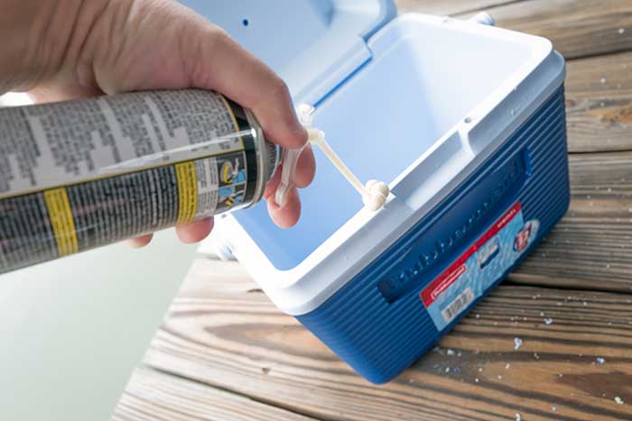 Inserting foam in each hole in cooler