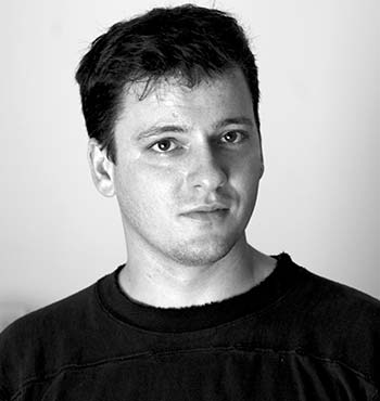 Black and white portrait of a young man John Landers wearing a black shirt