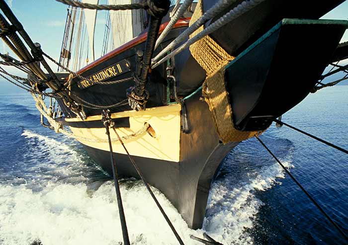 Bow of the Pride of Bailtimore II a squared-rigged sailling ship cruising through the water