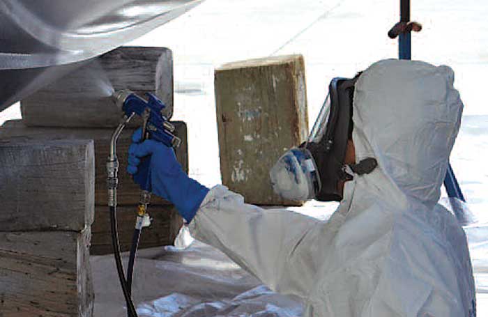Copper-based antifouling paint being sprayed on