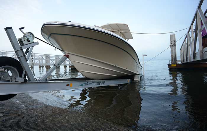 Bow and stern lines tied to a floating dock to control a powerboat after it floats free of the trailer