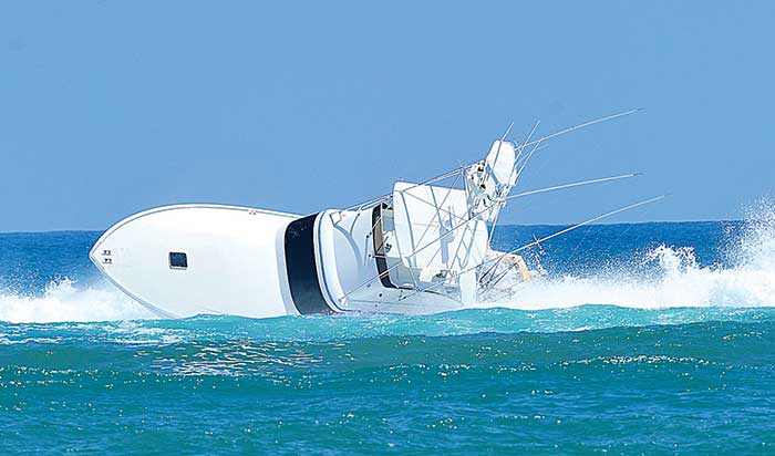 Breaking wave rolls large powerboat