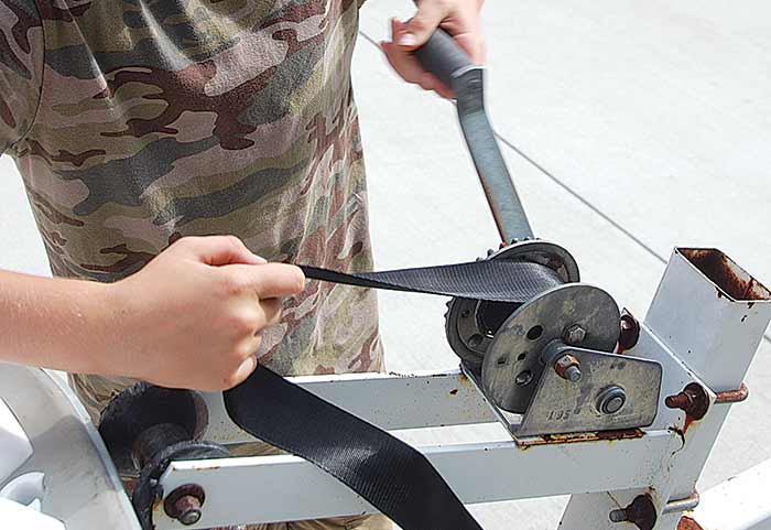 Wind new strap into winch drum