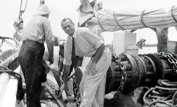 Bill McCoy helps heave up the anchor