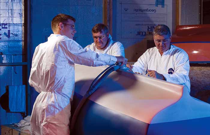 Students sanding hull