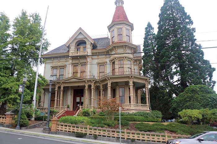 Victorian mansions overlook Astoria's waterfront shops