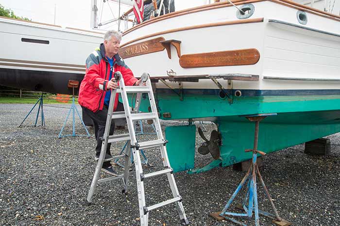 Climbing a ladder to inspect boat