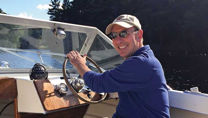 Gregory Grande at the helm of his 1974 Penn Yan