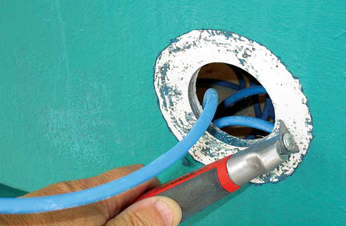 Using scraper to remove antifouling