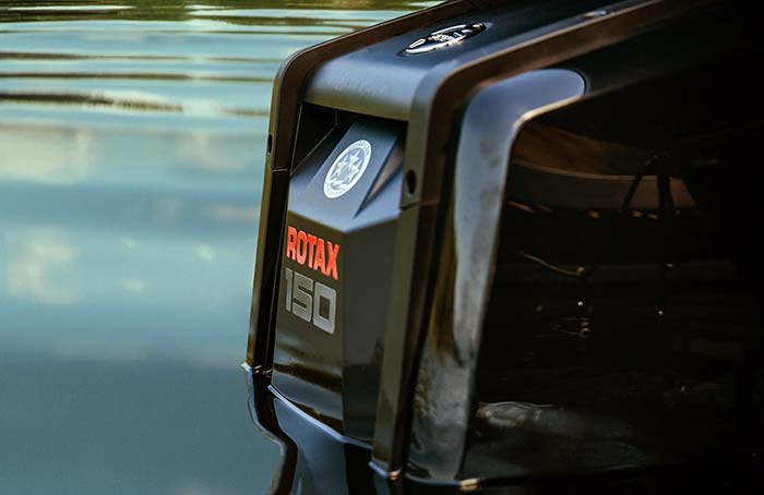 Closeup view of side and back of an Rotex 150 horsepower outboard boat engine