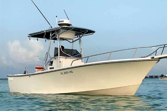 A white center-console powerboat afloat on the water