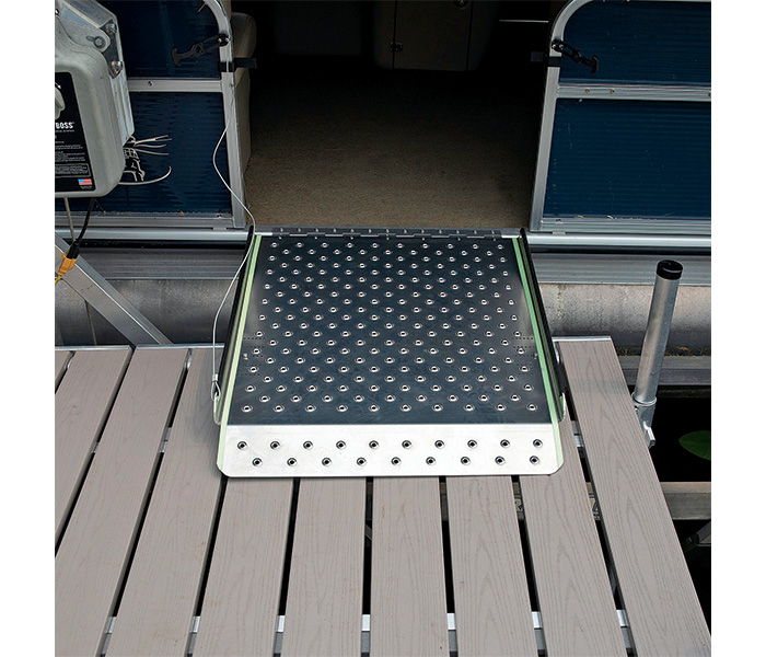 Glow tape on the sides of a pontoon boat side door docked.