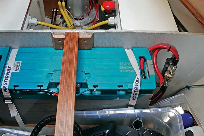 Mastervolt li-ion battery with the standards-required class "T" fuse to its right mounted on the bulkhead