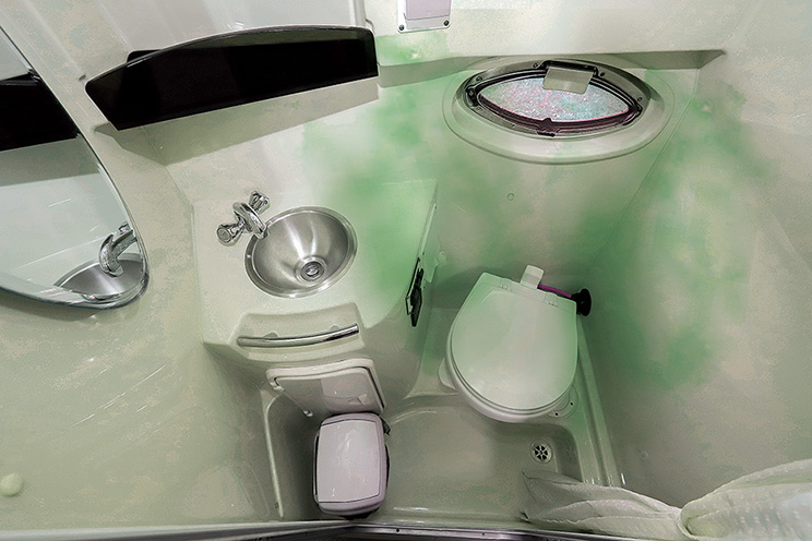 Overhead view of a bathroom with white sink and white toilet