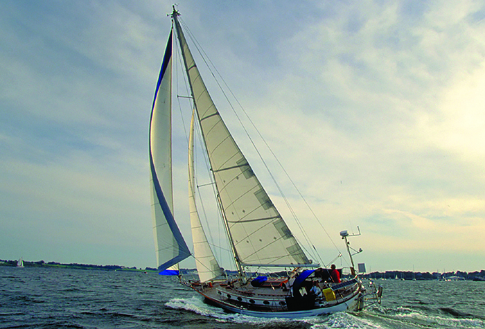 Large white sailboat in the open waters during daytime