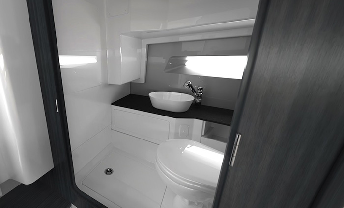 All white bathroom with dark charcoal colored cabinets.