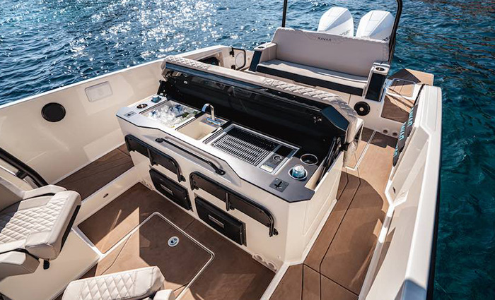 Overhead view of a black and white grill on a boat out on the water.