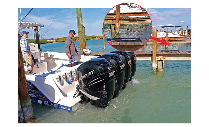 Photo highlighting a line hanging down over a slip next to one where a white vessel is backing into.