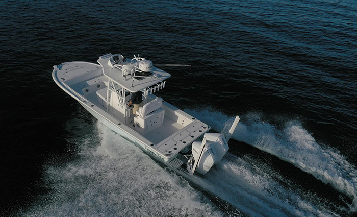 Ariel view of a large white vessel out in open waters.