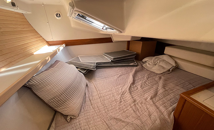 Sleeping area with wood paneling, vaulted ceiling and a skylight