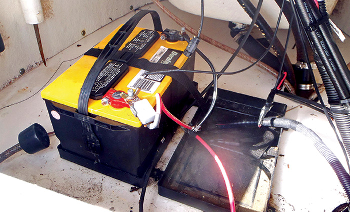 Black and yellow battery with red and black wires attached.