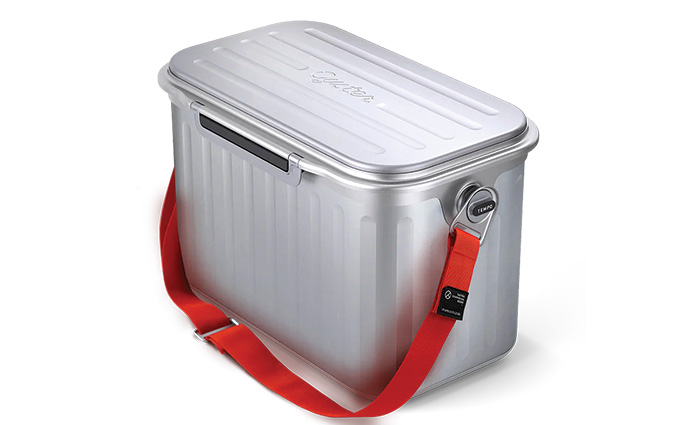 Silver cooler with a red strap.
