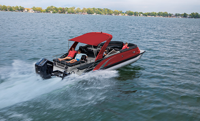 Red pontoon boat speeding through open waters.