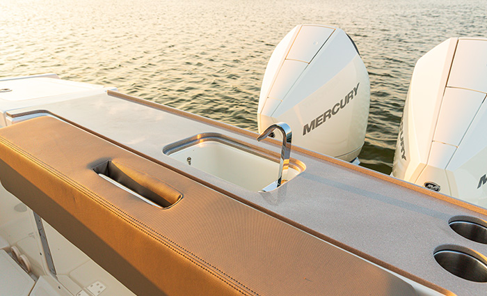 Transom at the stern of a boat featuring a sink and cupholders.