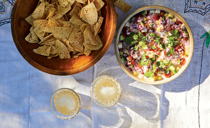 View from above of a bowl of chips and bowl of salsa.