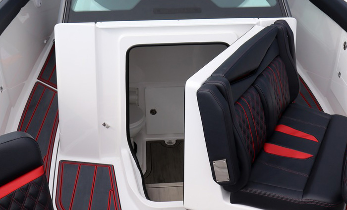 Open console door on a white boat revealing reveals a spacious area.