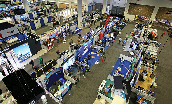 Aerial view of numerous tradeshow booths in a large convention center.