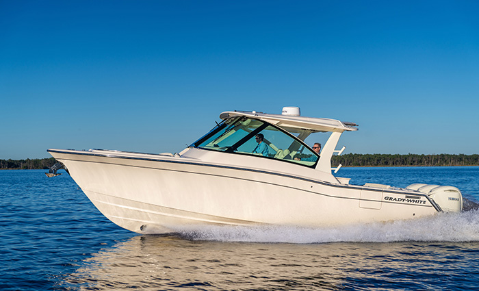 White vessel cruising through the water on a clear day.