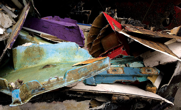 A large assortment of white, blue, red and purple disgaurded fiberglass. 