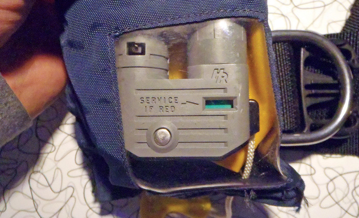 Status indicator inside a yellow and navy inflatable jacket.