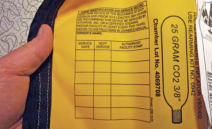 Inside of a yellow life jacket indicating a chart for the annual inspection.
