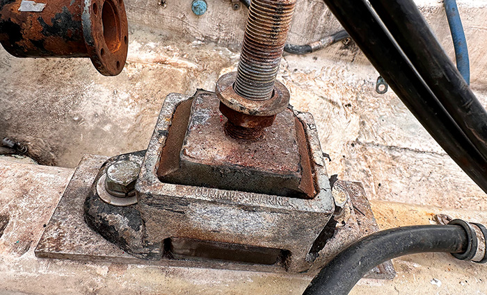 Up close view of an old and damaged engine mount.