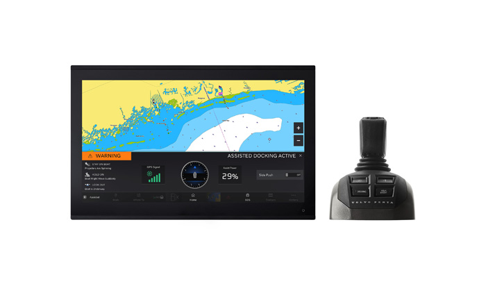 Black joystick next to black monitor with colorful radar displayed.