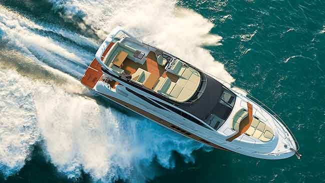 aerial shot of Sea Ray 650 Fly powerboat underway in dark blue/green water